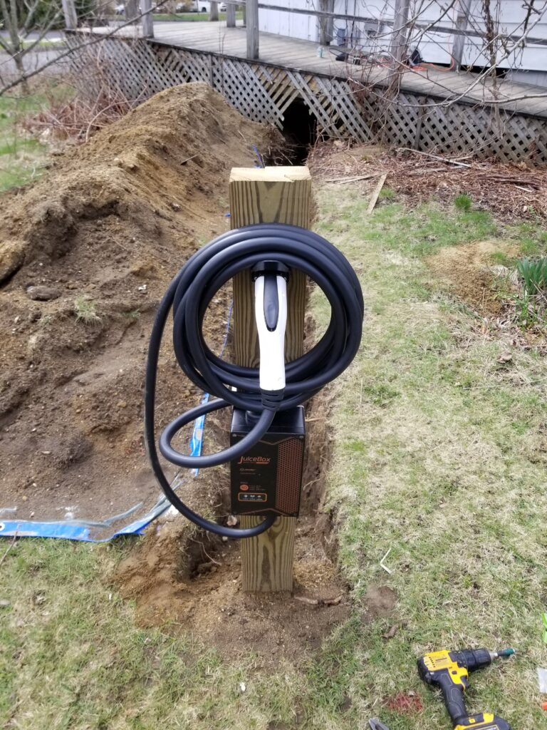 Licensed master electrician from Prevolt Electric finalizing a Level 2 EV charger installation at a Connecticut home.