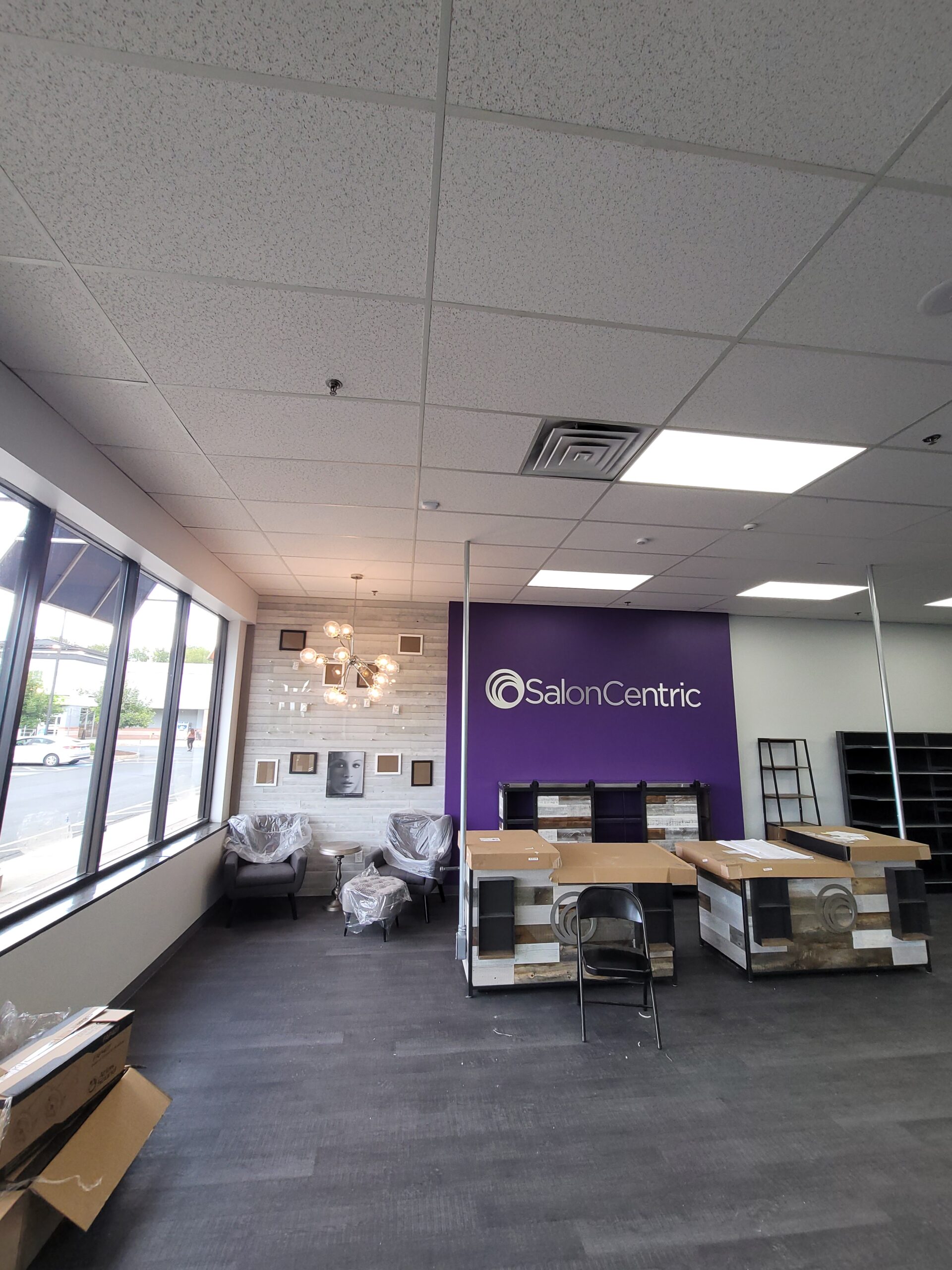 Licensed commercial electricians from Prevolt Electric completing a commercial fit-out with conduit, wiring, and LED lighting installation inside a Connecticut business facility.