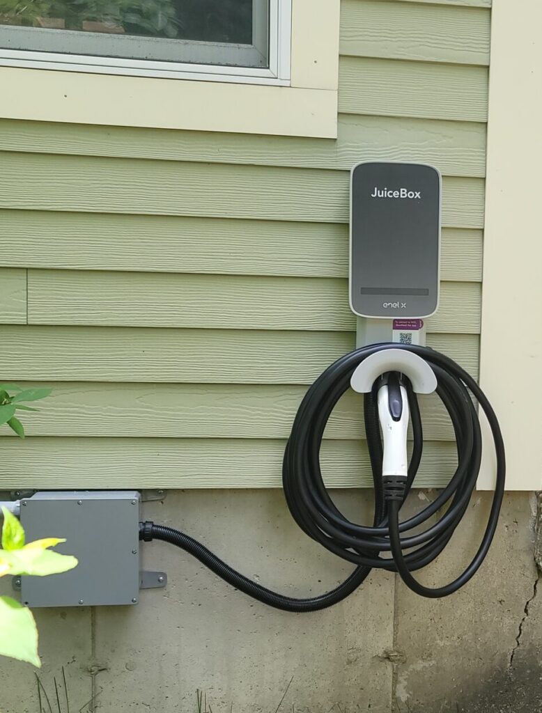 Licensed electrician installing a Level 2 home EV charger in Connecticut for faster, safer residential charging.