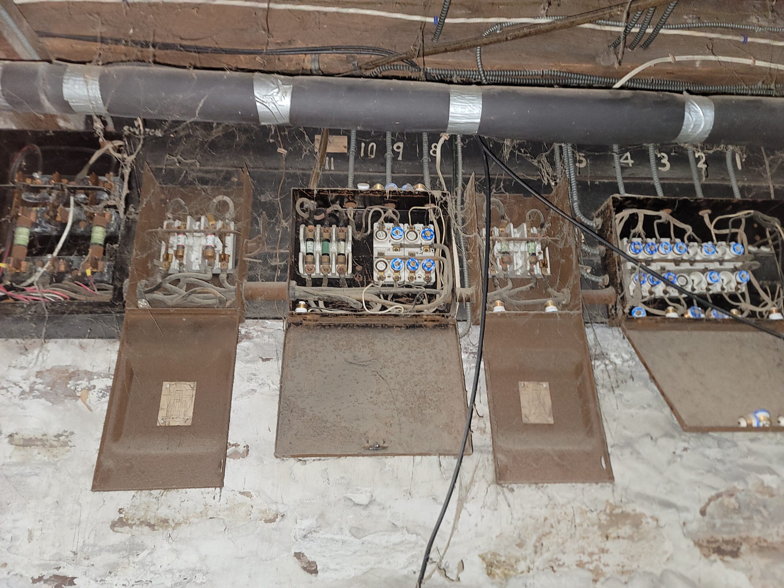 Old residential fuse box being replaced as part of a remodel project.