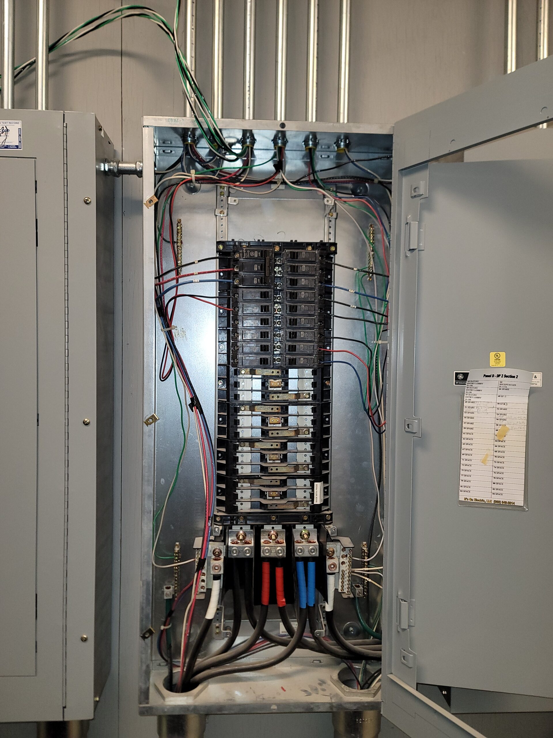 Newly installed commercial electrical panel with EMT conduit and branch circuit wiring completed by Prevolt Electric in Connecticut.