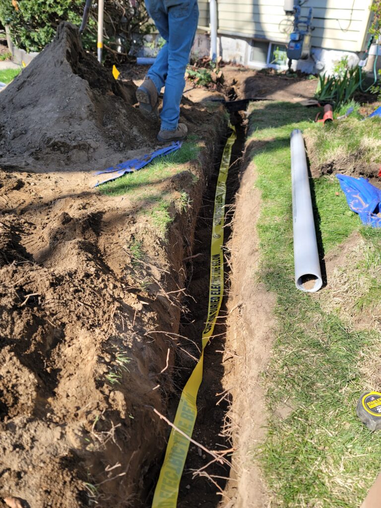 Licensed electricians performing underground conduit installation in Connecticut and Massachusetts