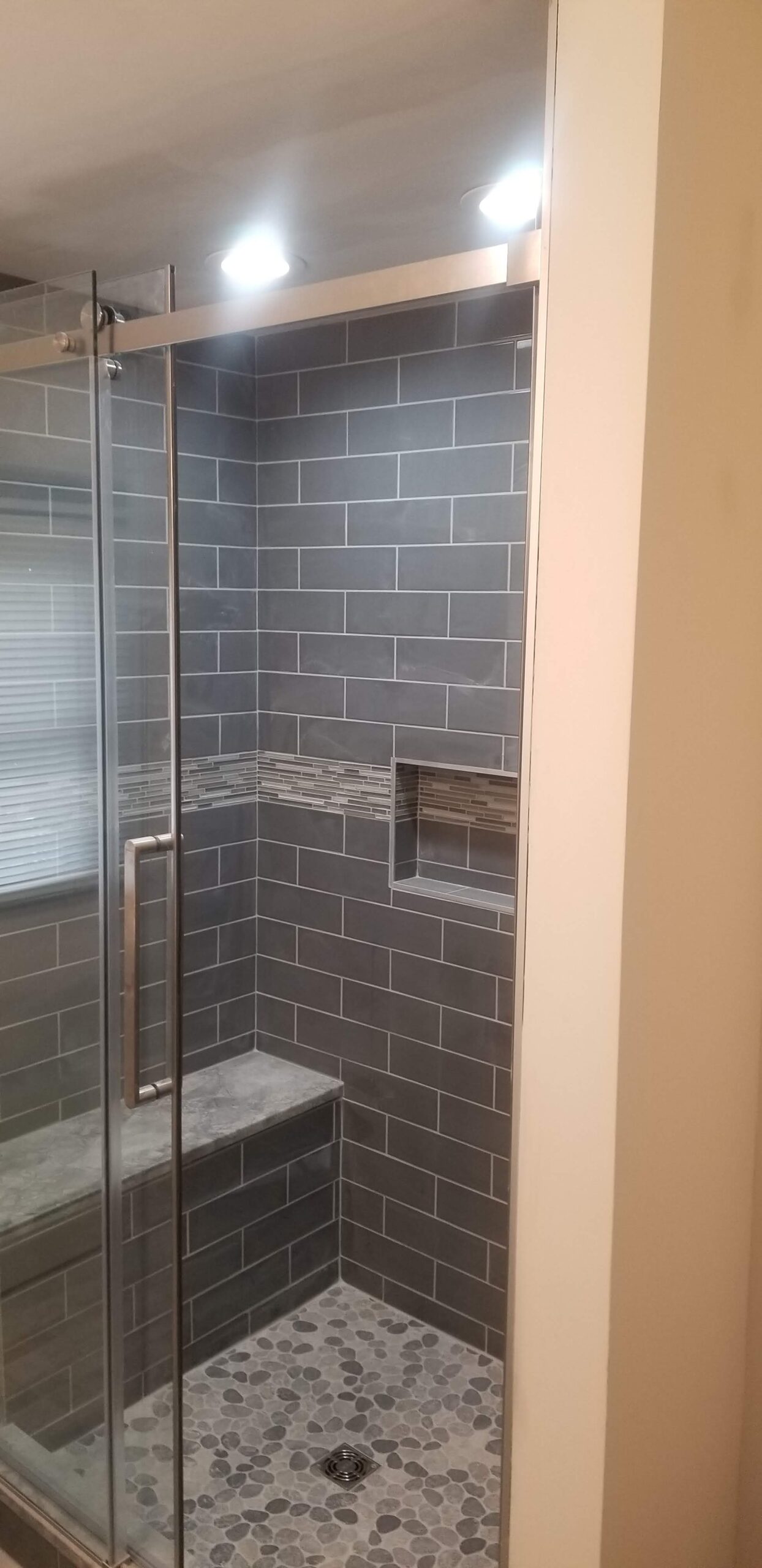 Modern tiled shower with recessed lighting installed by Prevolt Electric, featuring bright energy-efficient waterproof fixtures in Connecticut